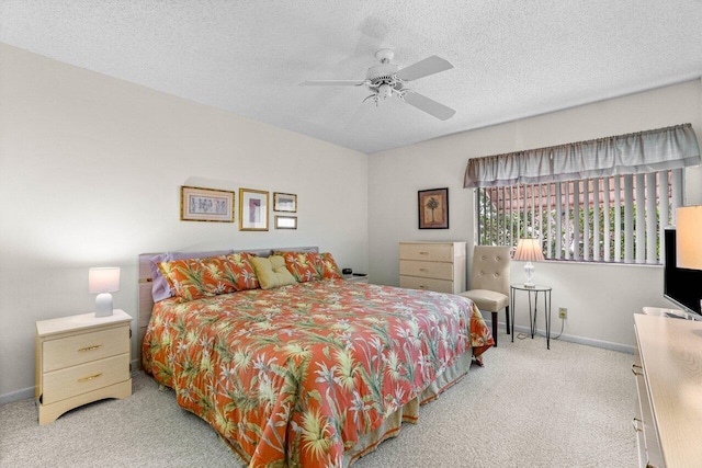 carpeted bedroom featuring a textured ceiling and ceiling fan