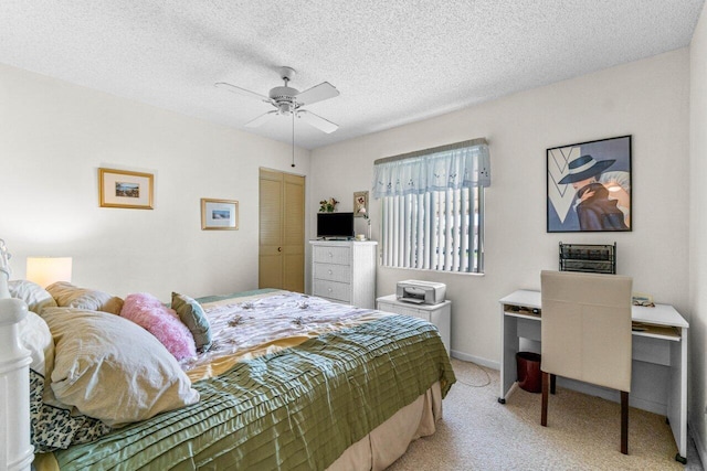 carpeted bedroom featuring a closet, a textured ceiling, and ceiling fan