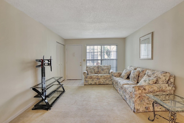 carpeted living room featuring a textured ceiling