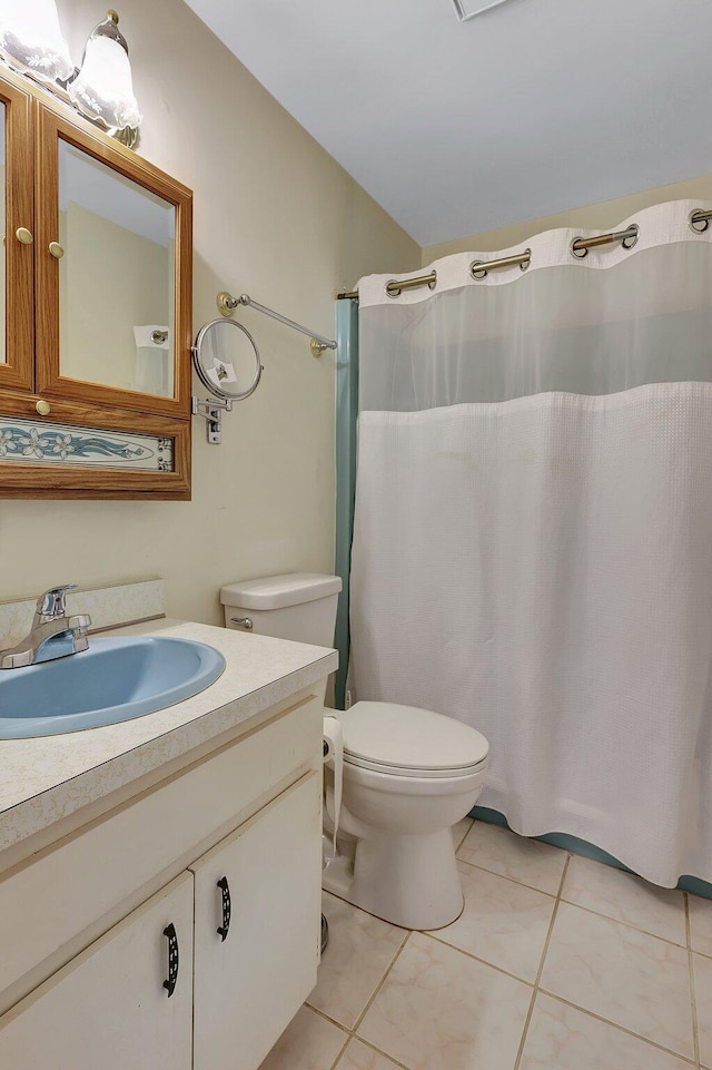 bathroom featuring vanity, toilet, tile patterned floors, and a shower with curtain