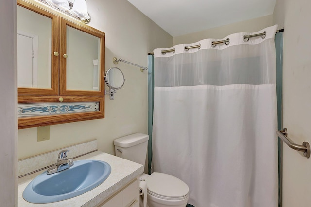 bathroom featuring vanity, walk in shower, and toilet