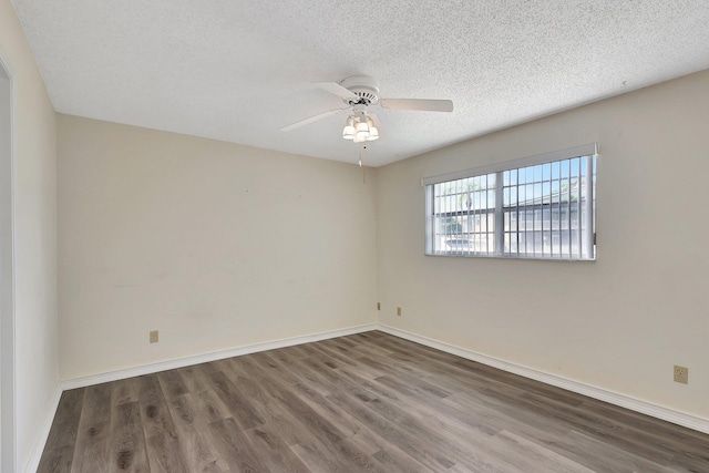 spare room with a textured ceiling, dark wood-type flooring, and ceiling fan