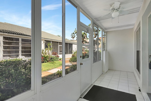 unfurnished sunroom with a wealth of natural light and ceiling fan