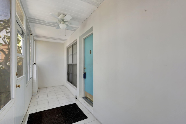 sunroom / solarium featuring ceiling fan