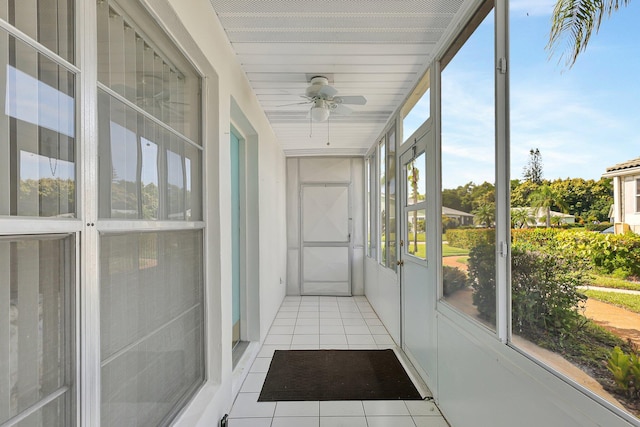 sunroom / solarium with ceiling fan and a healthy amount of sunlight