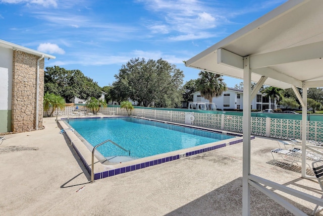 view of swimming pool featuring a patio area