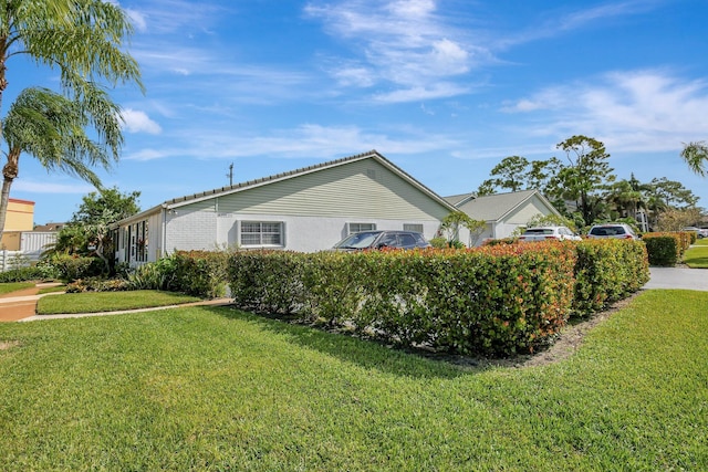 view of side of home with a lawn