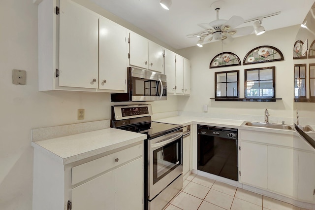2109 SE Wayne Rd Unit 2109, Stuart, FL 34994 - kitchen with appliances with stainless steel finishes, a sink, rail lighting, light tile patterned flooring, and white cabinets
