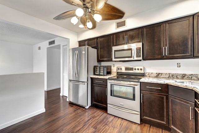 kitchen with ceiling fan, dark hardwood / wood-style flooring, light stone countertops, dark brown cabinetry, and stainless steel appliances