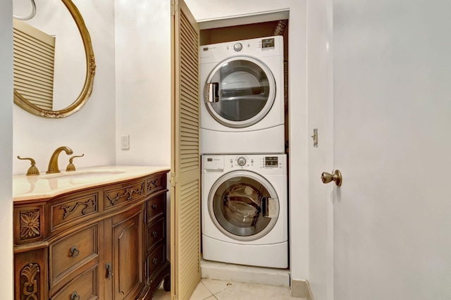 washroom with sink, stacked washer and clothes dryer, and light tile patterned floors