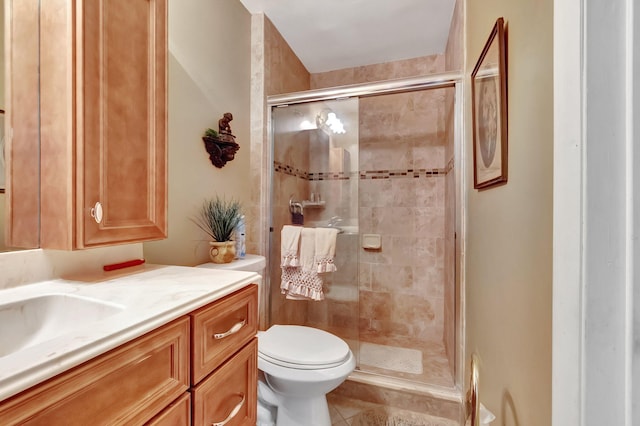 bathroom with toilet, walk in shower, vanity, and tile patterned flooring