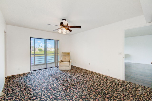 unfurnished room with ceiling fan and carpet