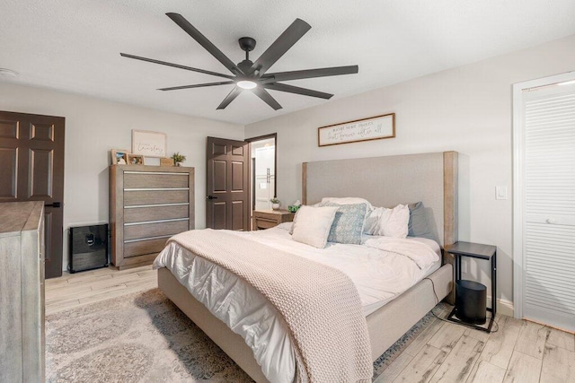 bedroom with light wood-type flooring and ceiling fan