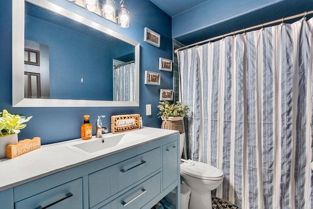 bathroom featuring vanity and toilet