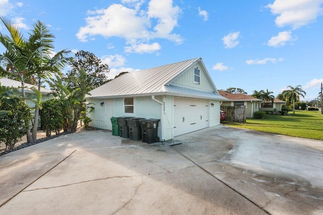 view of home's exterior featuring a garage and a lawn