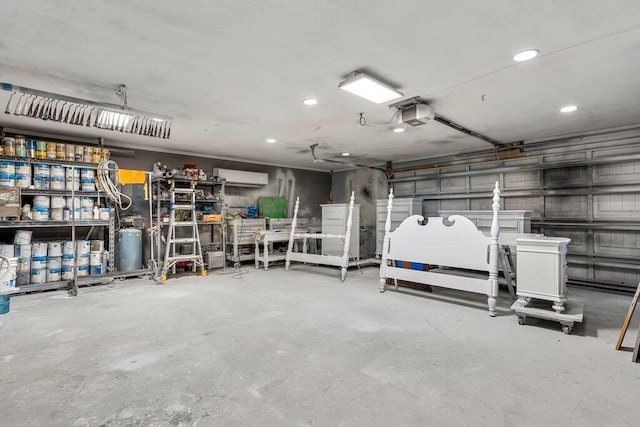 garage featuring a garage door opener and a wall unit AC