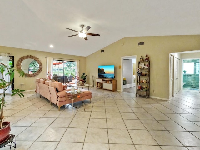 tiled living room featuring ceiling fan and lofted ceiling