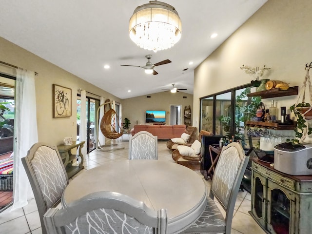 dining area featuring ceiling fan with notable chandelier, lofted ceiling, and light tile patterned floors