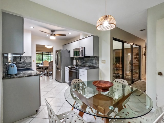 dining room with ceiling fan, sink, and light tile patterned flooring