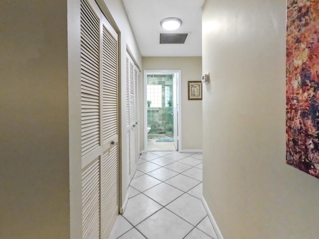 hall with light tile patterned floors