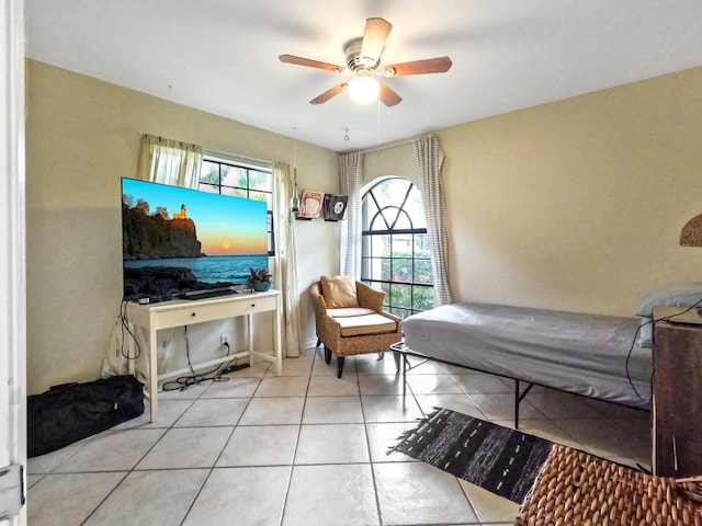 bedroom with ceiling fan and light tile patterned floors