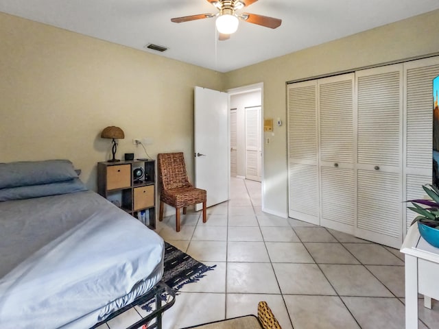 tiled bedroom featuring a closet and ceiling fan