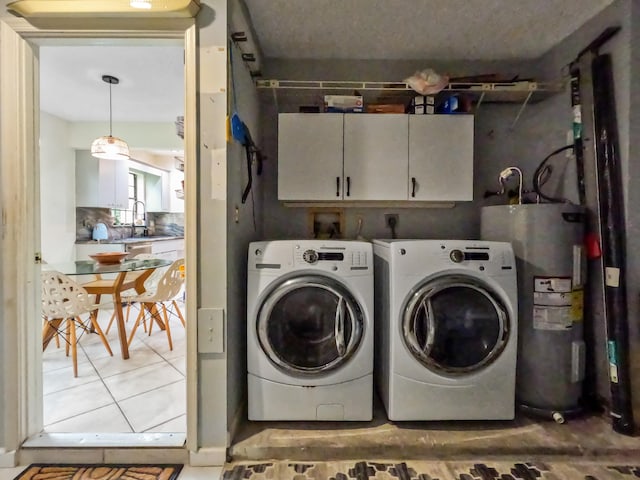 laundry area with sink, cabinets, separate washer and dryer, electric water heater, and tile patterned flooring