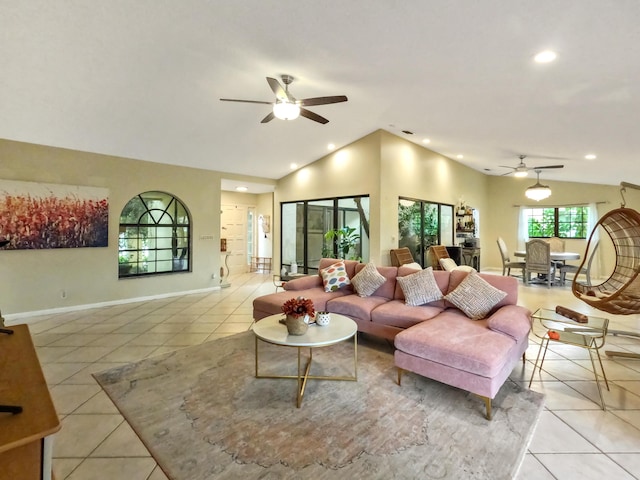 tiled living room featuring ceiling fan and vaulted ceiling