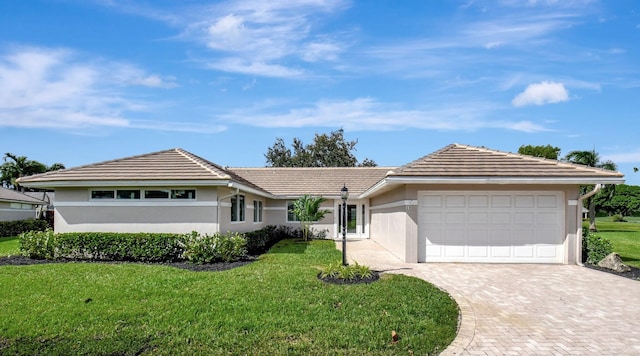 single story home featuring a front lawn and a garage