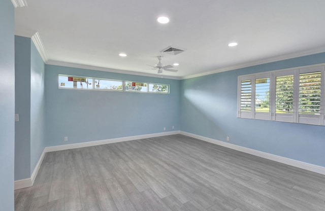 empty room with crown molding, ceiling fan, light hardwood / wood-style floors, and plenty of natural light