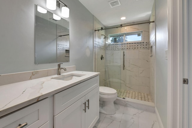 bathroom with vanity, toilet, and walk in shower