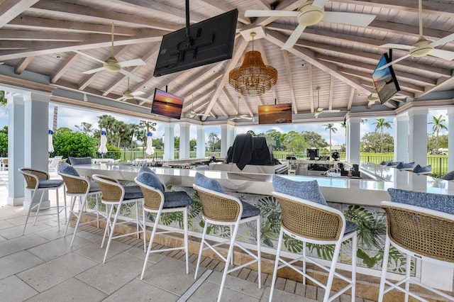 view of patio / terrace with a bar and ceiling fan