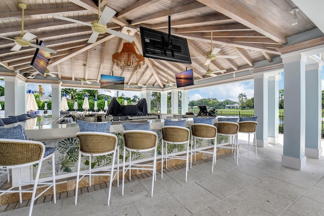 view of patio / terrace featuring an outdoor bar and ceiling fan