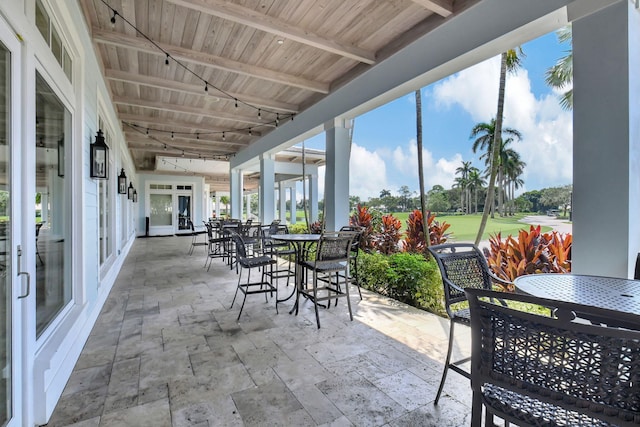 sunroom / solarium with wooden ceiling, beamed ceiling, and plenty of natural light