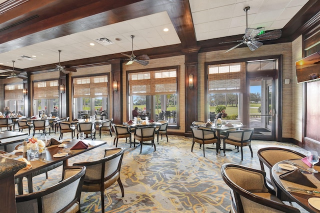 dining space with beam ceiling, light colored carpet, and ornate columns