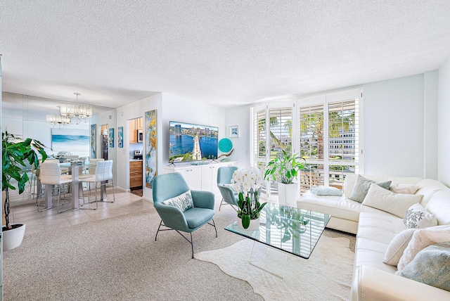 living room with a chandelier, a textured ceiling, and light tile patterned floors