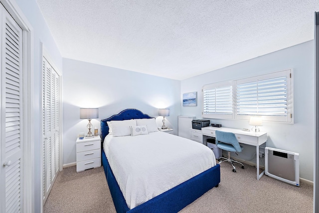 carpeted bedroom with a textured ceiling and heating unit