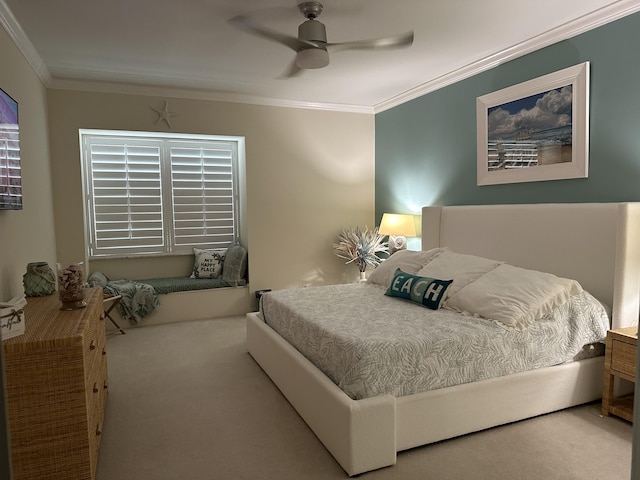 bedroom with ceiling fan, crown molding, and carpet floors