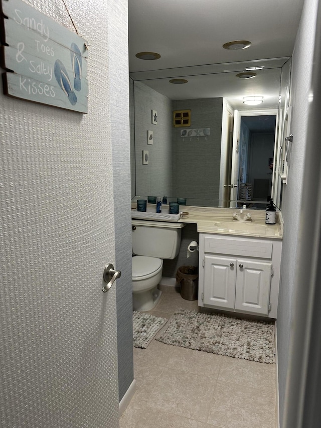 bathroom featuring tile patterned floors, vanity, and toilet