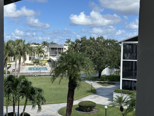 view of property's community with a patio, a yard, and a pool