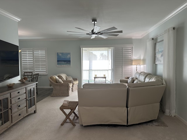 living room with light colored carpet, ceiling fan, and ornamental molding