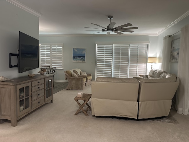 living room featuring ceiling fan, light colored carpet, and ornamental molding