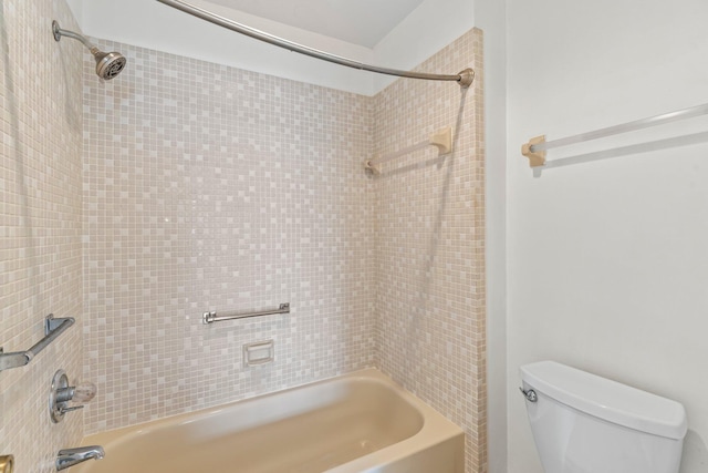 bathroom with toilet and tiled shower / bath combo