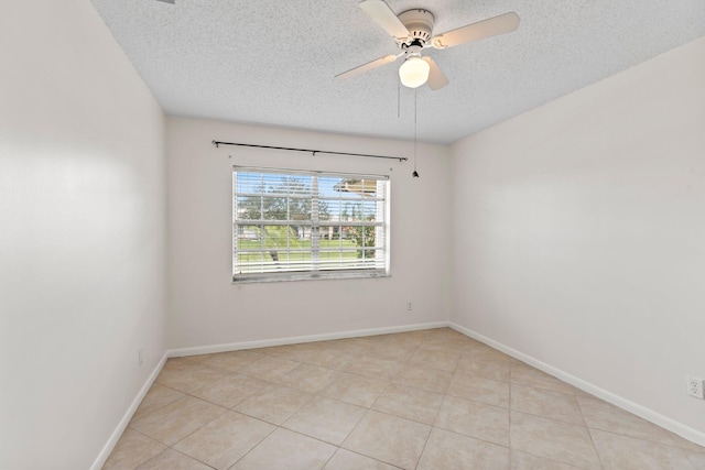 tiled empty room with a textured ceiling and ceiling fan