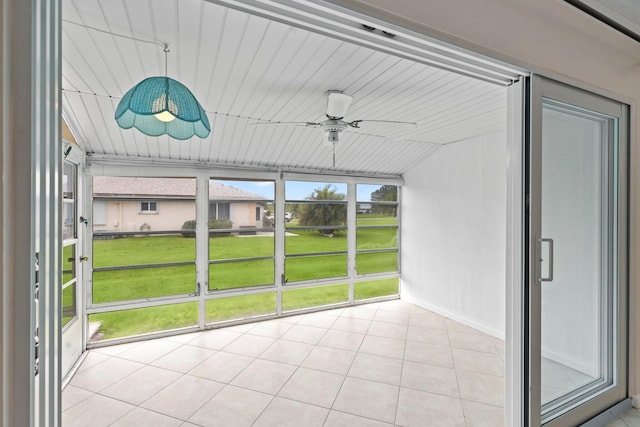 unfurnished sunroom featuring ceiling fan and vaulted ceiling