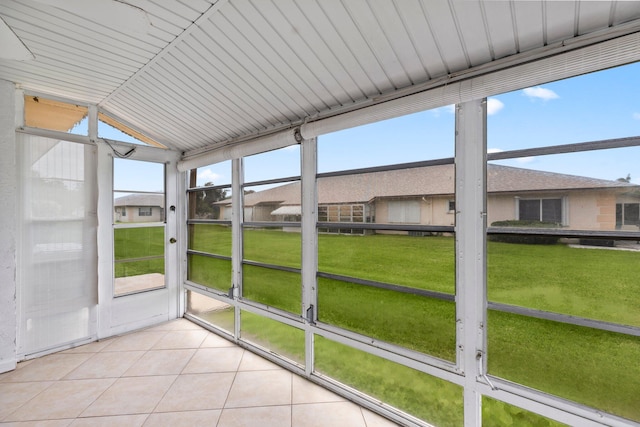 unfurnished sunroom featuring vaulted ceiling