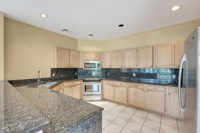 kitchen featuring light brown cabinets, tasteful backsplash, stainless steel appliances, and sink