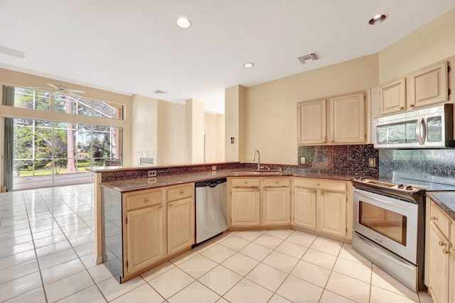 kitchen with sink, light tile patterned flooring, dishwasher, electric stove, and kitchen peninsula