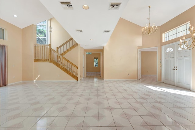 entryway with a high ceiling and light tile patterned floors