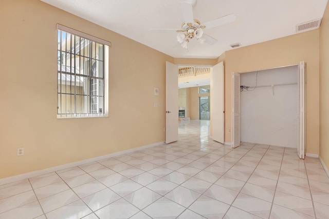 unfurnished bedroom featuring light tile patterned floors, a closet, and ceiling fan